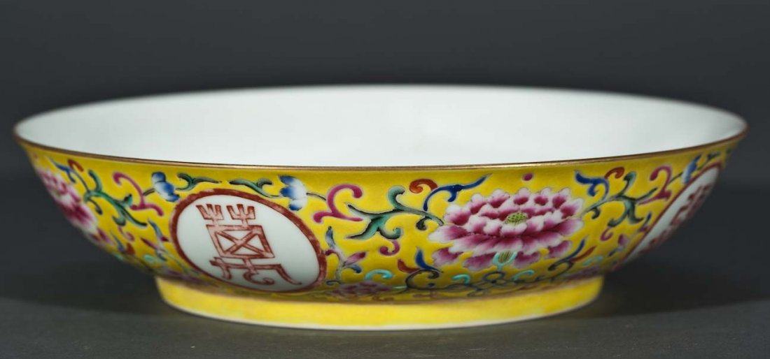 Chinese Famille Rose Yellow Shallow Bowl with Red bats: The interior is decorated with 5 bats surrounding the character for longevity (shou) which symbolizes a wish for longevity and the five blessings. The bowl with a yellow ground decorated with evenly s
