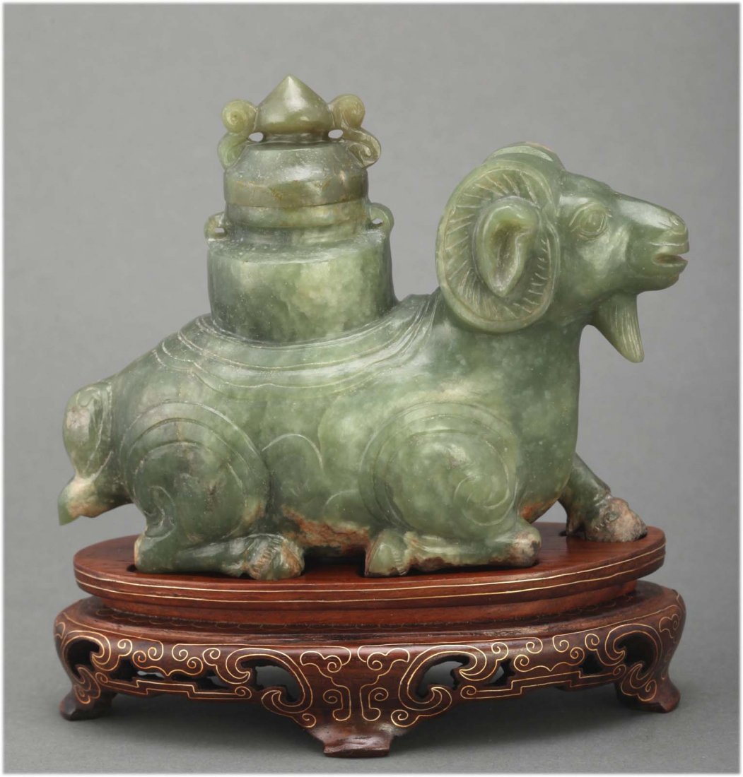 Chinese antique carved jade sheep on wood base: Holding a covered vase on the back. Circa 20th C. dimensions: 5" H X 4.75" Long K016W