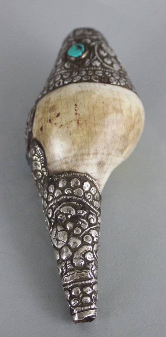 Nepalese Ritual Conch Shell: This beautiful Ritual Conch Shell is carved with silver and semi precious stones . Dimensions 5.5" x 2.5", CS7, K1W51