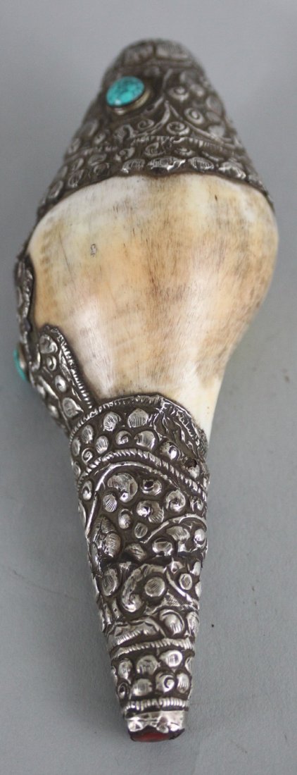 Nepalese Ritual Conch Shell: This beautiful Ritual Conch Shell is carved with silver and semi precious stones . Dimensions 5.5" x 2.5", CS9, K1W51