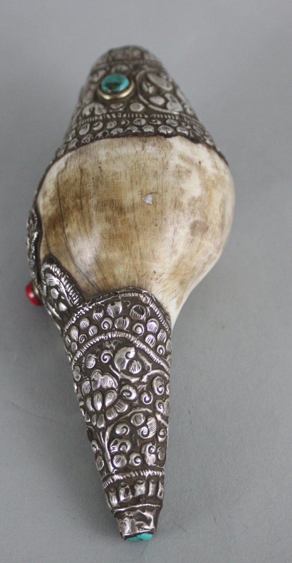 Nepalese Ritual Conch Shell: This beautiful Ritual Conch Shell is carved with silver and semi precious stones . Dimensions 5.5" x 2.5", CS13, K1W51
