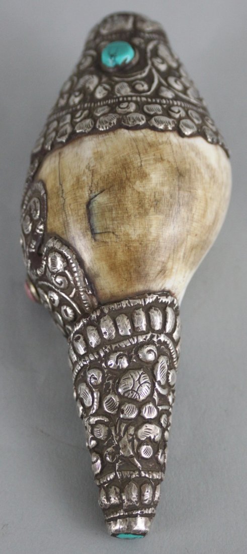 Nepalese Ritual Conch Shell: This beautiful Ritual Conch Shell is carved with silver and semi precious stones . Dimensions 5.5" x 2.5", CS10, K1W51