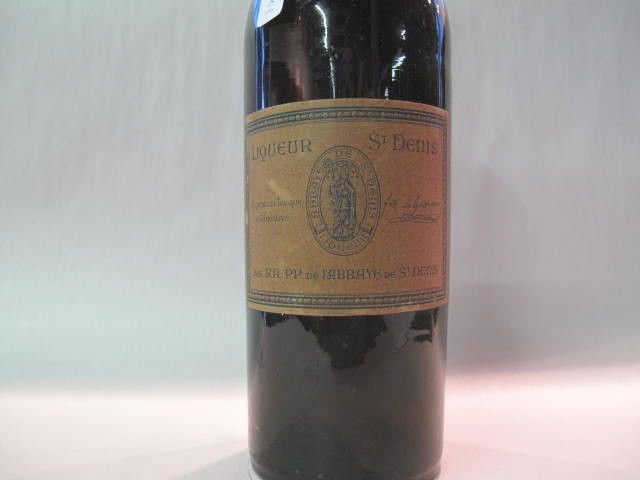 Liqueur St-Denis: This wine bottle will be sold in auction with S.A.Q.approbation. Note: All wine bottles value were upraised $100-$200, even if they are worth more or less. We all start them at $10, because these bott