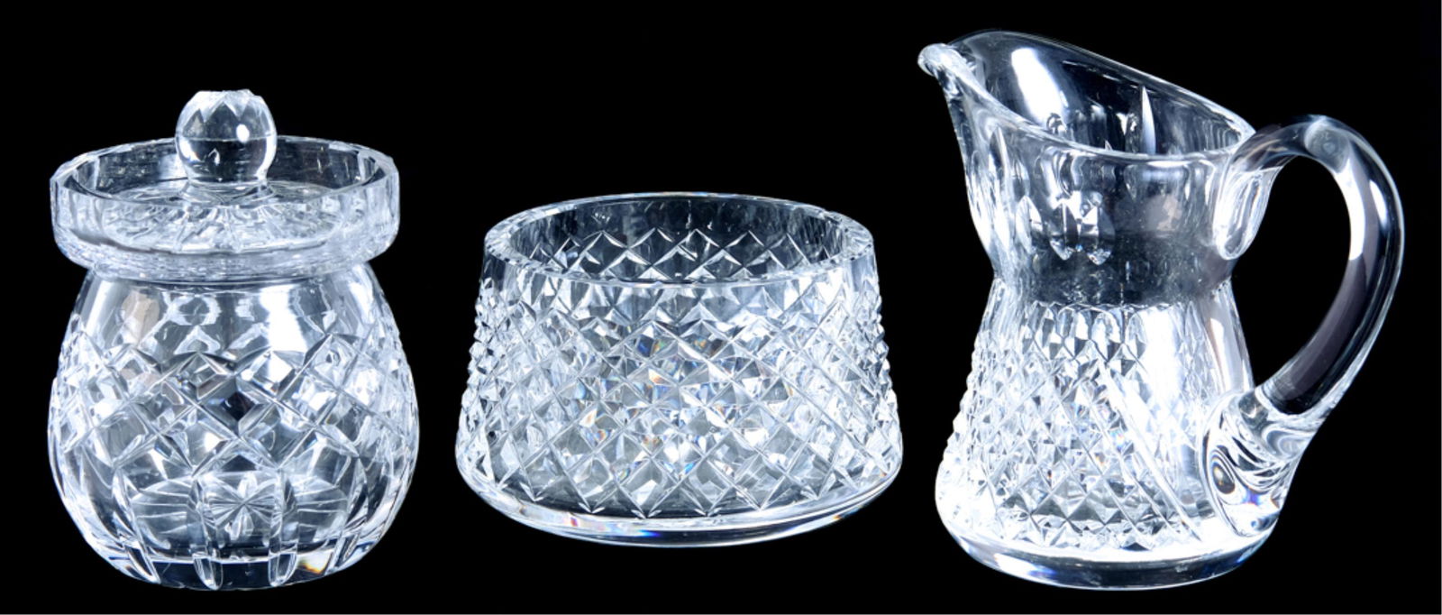 3 Pcs Waterford Crystal Table Accessories: Three pieces of Waterford crystal table accessories comprising a lidded jam/jelly jar, flat bottom open sugar and creamer. All with acid etch Waterford mark. Approx. heights 2.5" and 4.5".
