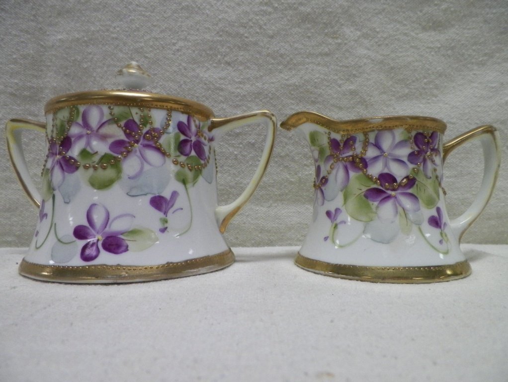 Nippon Creamer and Sugar Maple Leaf Mark Violets: C 1910. Sugar 4" Tall 5-5/8" Handle to Handle. Creamer 2-7/8" Tall 4.25" Handle to Spout. Light gold wear.