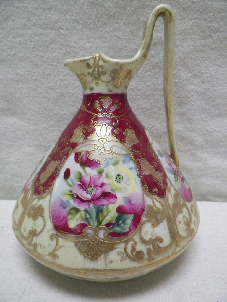 Nippon Moriage Pitcher Maple Leaf Mark Floral: C 1910. 7.5' Tall 6"W. Wear to gold handle and other spots at bottom/base design.