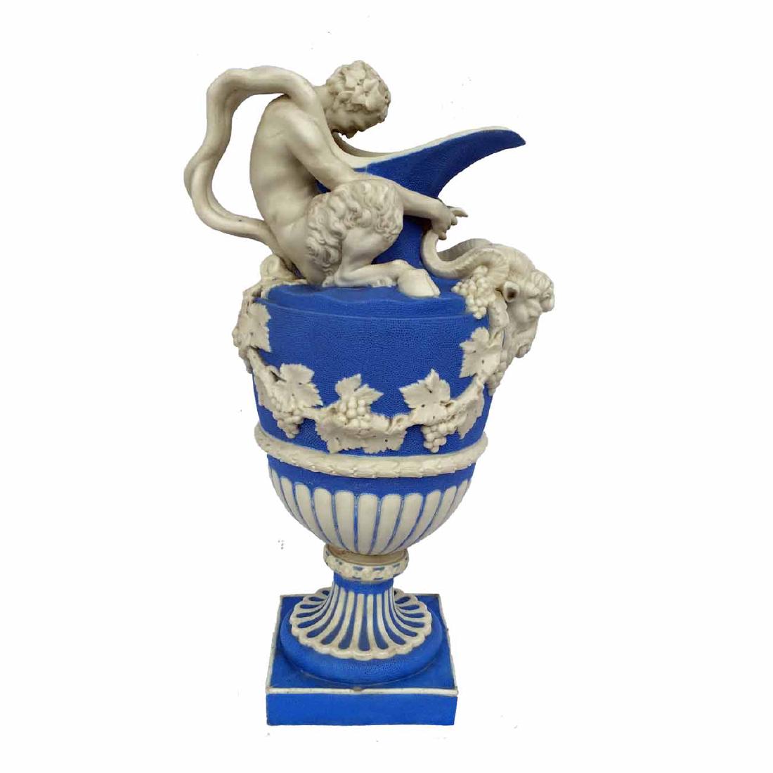 19th Century Jasperware Wine Ewer: 13 4/5" high. 19th Century porcelain jasperware with a satyr holding a ram's head. Decorated with grape leaves throughout.