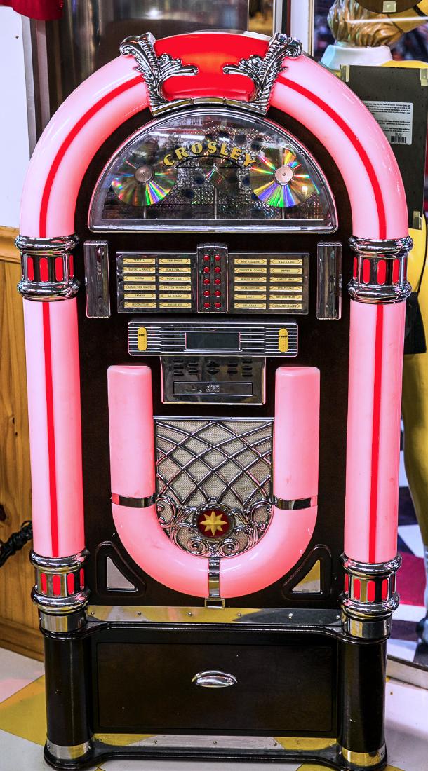 Jukebox: Crosley. Compact disc. 53"x14"x26". Lighted exterior. Model CR12-1. NOTE - If unable to pick locally, Buyer is responsible for arraging all packing and shipping