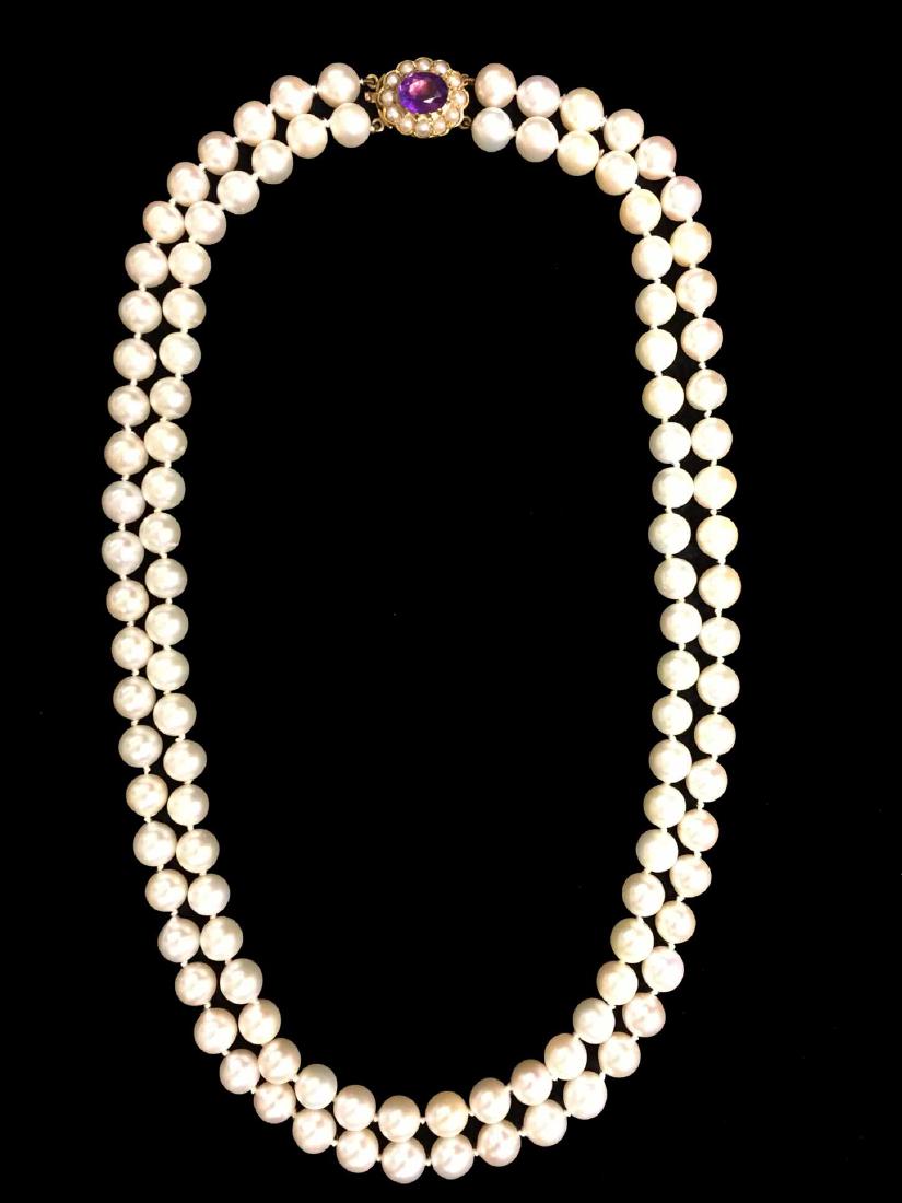 Mikimoto Pearl Set: Approx. 12" double strand. (110) cultured white pearls with a silver hue (ranging in size from 7.4 mm - 7.6 mm). 14K yellow gold clasp. Clasp set with (1) oval cut purple stone and small white culture