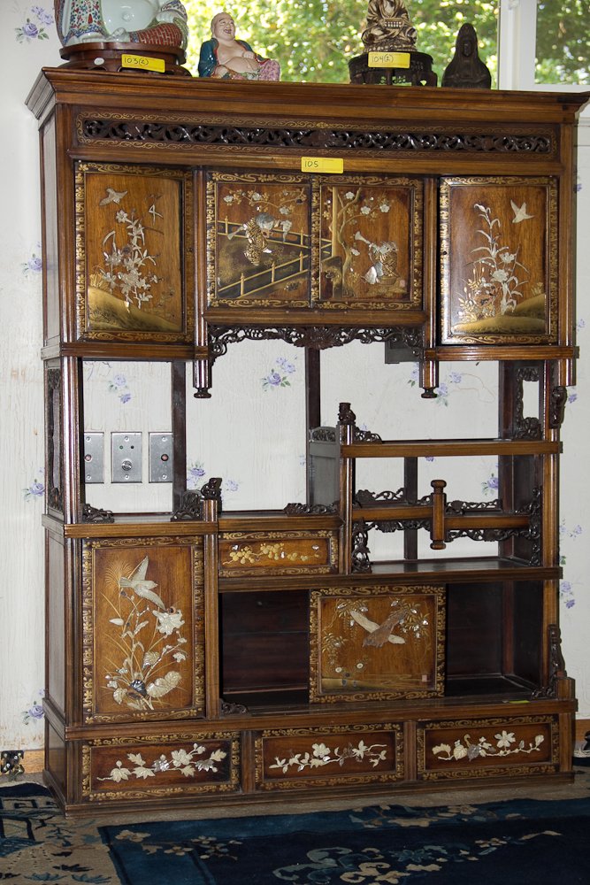 Japanese Pietra Dura Inlaid Cabinet: (1) 56 1/2" h x 44" w. Early 20th Century, Japanese. Flat top with a protruding cornice. Scrolling pierced frieze. Multiple doors, drawers and shelves. The doors and drawers are inlaid with mother of 
