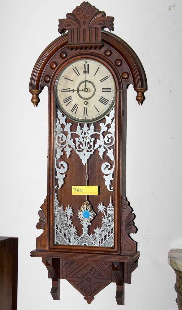 Wall Clock: (1) 42"l. 19th Century, wall clock. Spring wound, 8 day, time only. Walnut case with a reverse painting on glass. NOTE: Glass damaged, AS IS. Shipping: USPS or Fedex. $115.00. We will ship internation
