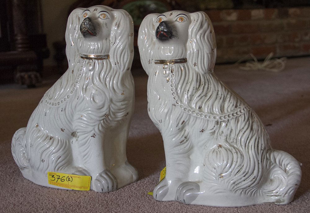 Staffordshire Dogs: (1 pair) 15"h x 12"w. 19th century. White porcelain body with hand painted gilt, black and red accents. Unmarked. Shipping: USPS or Fedex. $60.00. We will ship internationally for the actual shipping