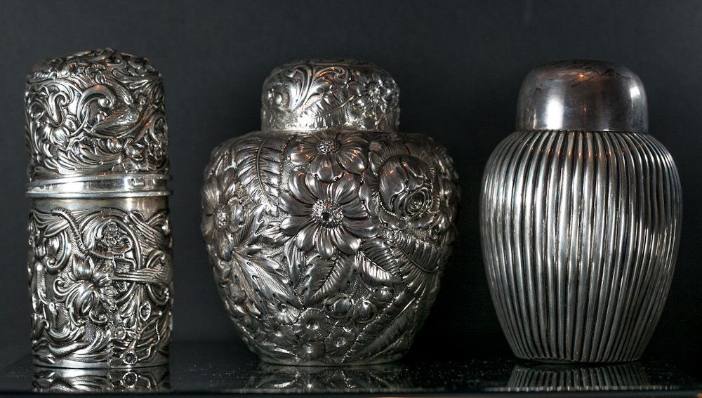 Sterling Silver Tea Caddies: (3) Total. Including: (1) 5"h, marked: Sterling with Gorham touch marks, relief sunflower design, total weight 6 oz troy; (1) 5"h. marked: Sterling 7 Shreve Crump & Low Co., reeded design, total weigh