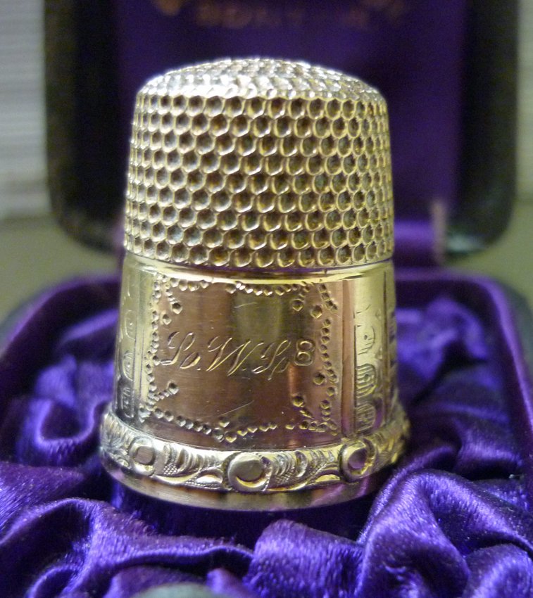 Gold Thimble: (1) 14K yellow gold. Incised mountain landscape scene. Initial: L.W.L. Size 8. Total weight: 4.4 grams troy. Includes the original box from C.A.W Crosby, Boston.