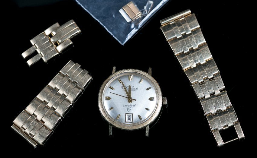 Lucien Piccard Automatique Sea Shark 14K Gold Watch: (1) 14K yellow gold band. Circular 14K yellow gold case and bezel. Circular silver dial with numeral markers. Marked: Lucien Piccard, Waterproof, 14K gold 15265. The band is unattached, ( 28.9 grams t