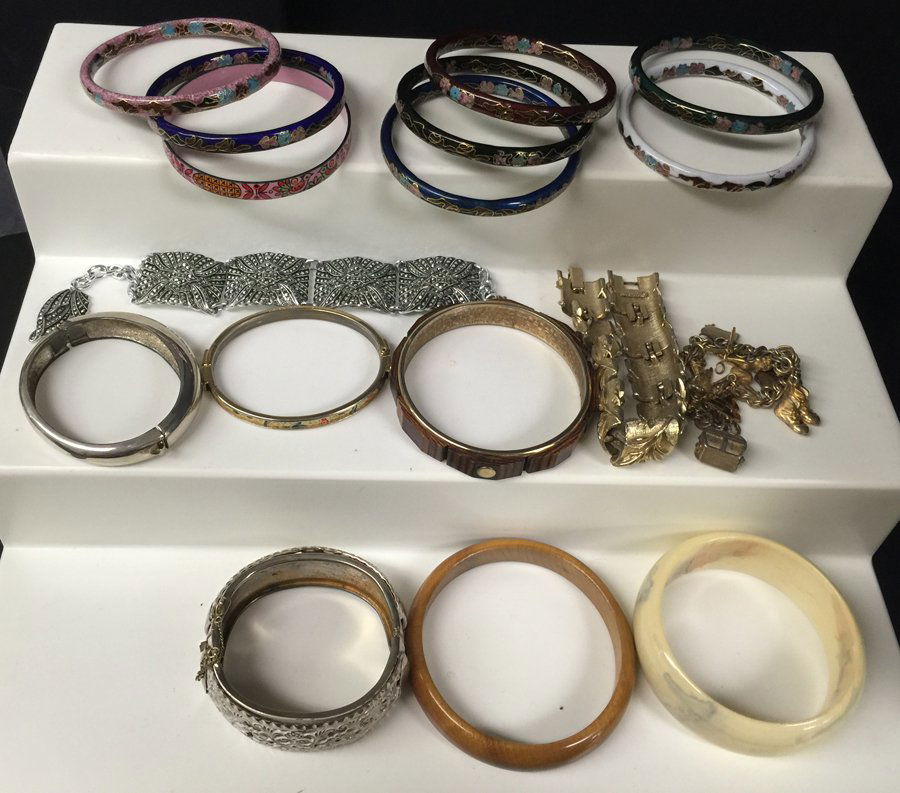 Collection of (17) Bracelets: Including: (8) cloisonn, (1) bakelite bangle, (1) brass bangle with white painted finish, (2) wood bangles, (1) misc. bangle, (1) gold plated charm bracelet, (2) link bracelets, (1) silver plated bang