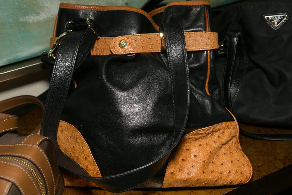 Vintage Mark Cross Ostrich Leather Purse: (1) 15"w x 12"h. Black leather with ostrich leather accents and straps. Two black leather straps with black leather carrying strap.