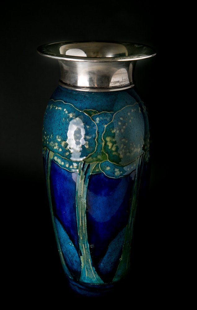 Moorcroft Moonlit Blue Sterling Silver Vase: (1) 11 1/4"h x 5"dia. Sterling silver, flared lip marked: 10015. Base marked: Made in England Moorcroft.