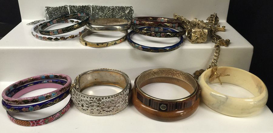 Collection of (17) Bracelets: Including: (8) cloisonnÃ©, (1) Bakelite bangle, (1) brass bangle with white painted finish, (2) wood bangles, (1) misc. bangle, (1) gold plated charm bracelet, (2) link bracelets, (1) silver plated