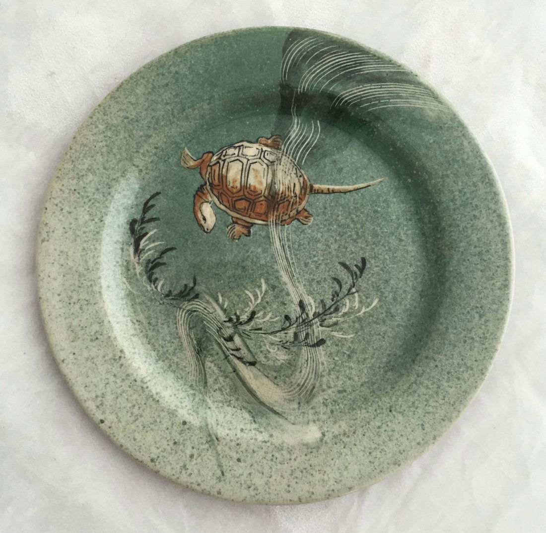 William. P. McDonald Rookwood Plate: (1) 6 1/4" dia., Date: 1885, #202. Artist: William. P. McDonald. Gray with a green glaze. Seaweed and turtle design.