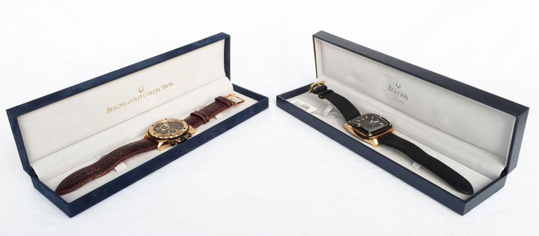 (2) Bulova Gold Collection Watches: (2) Bulova, Marine Star. Gold plated bezel. (1) with a black leather strap. Includes original box. Unworn. (1) with a brown crocodile strap. Slightly worn. Includes original box.