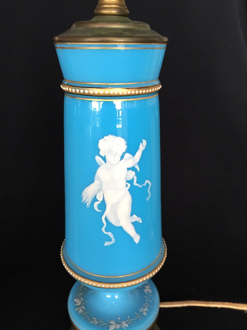 Mary Gregory Glass Lamps: (2) 27"h. Blue glass with gilt trim and white dots. (1) Cherub and heart quiver of arrows design and cherub and wreath and quiver of arrows design.