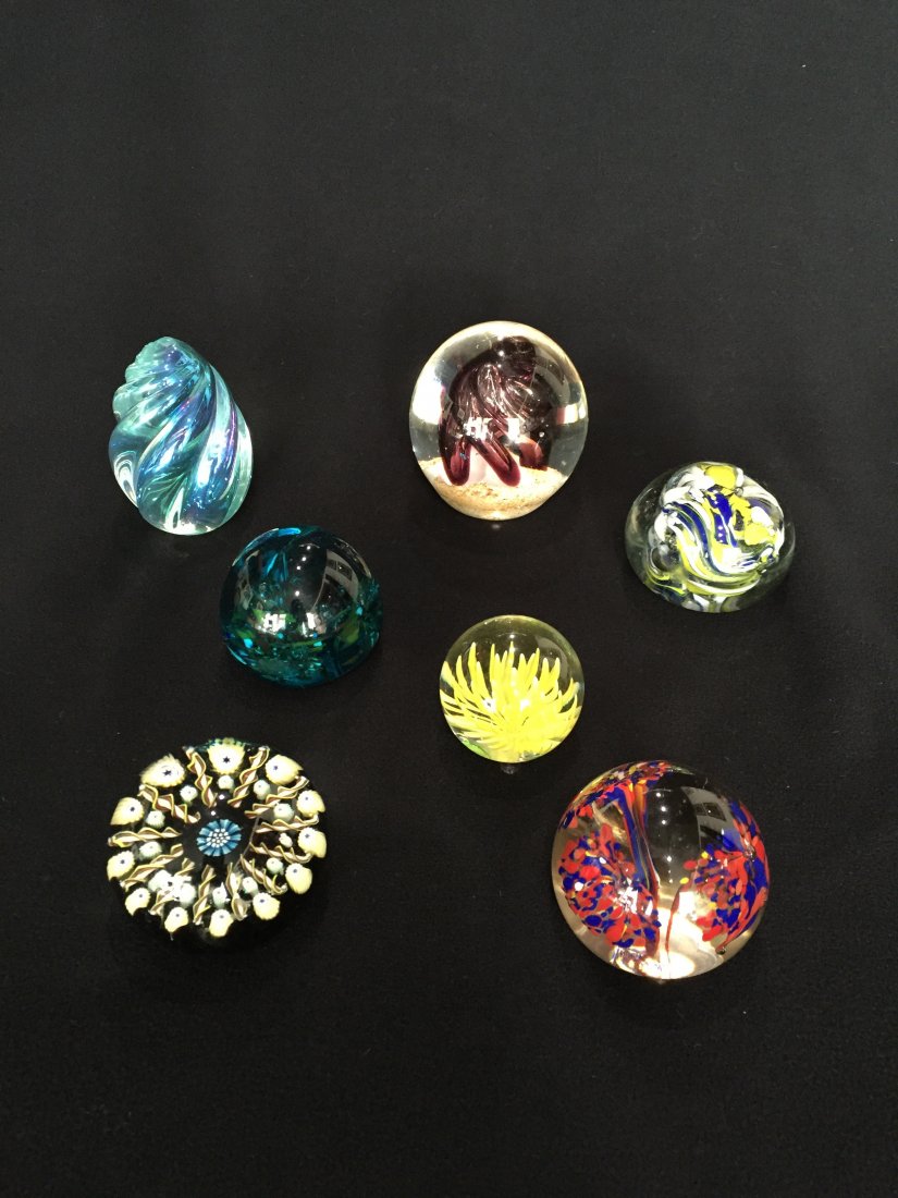 (7) Glass Paperweights: Including: (1) 1 3/4"h x 2 1/4", marked: Made in Scotland, millefiori in black, blue, yellow and brown design. (1) 3 1/8"h, burgundy center swirl. (1) 3 1/4"h Egg, opalescent swirl design. (1) 2"h, bl