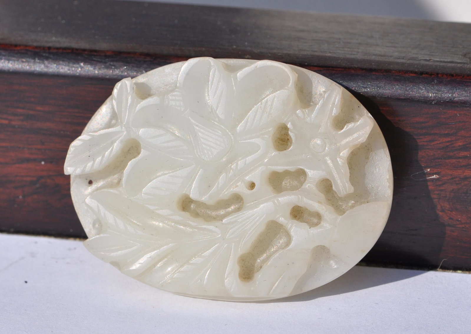 Chinese White Jade Plaque: Carved in flower. It measures 2" across. Ming Dynasty. Good condition with age wears.