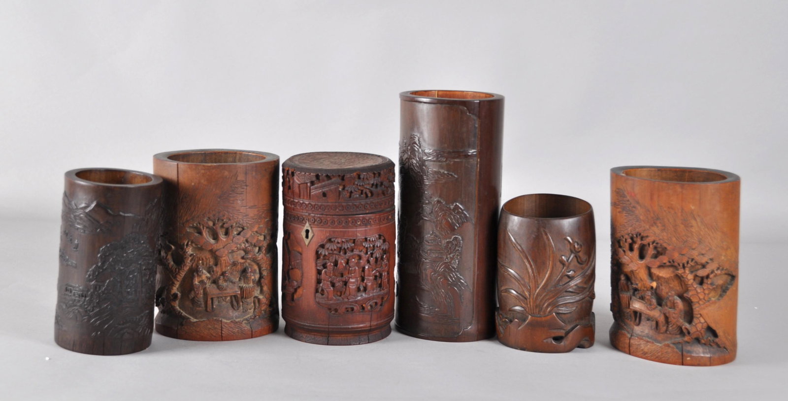 Chinese Six Bamboo Brush Holders: Carved in different patterns. Tallest one 9" tall, the smallest one 5.25" tall. 19th. C.. Good condition with age wears.