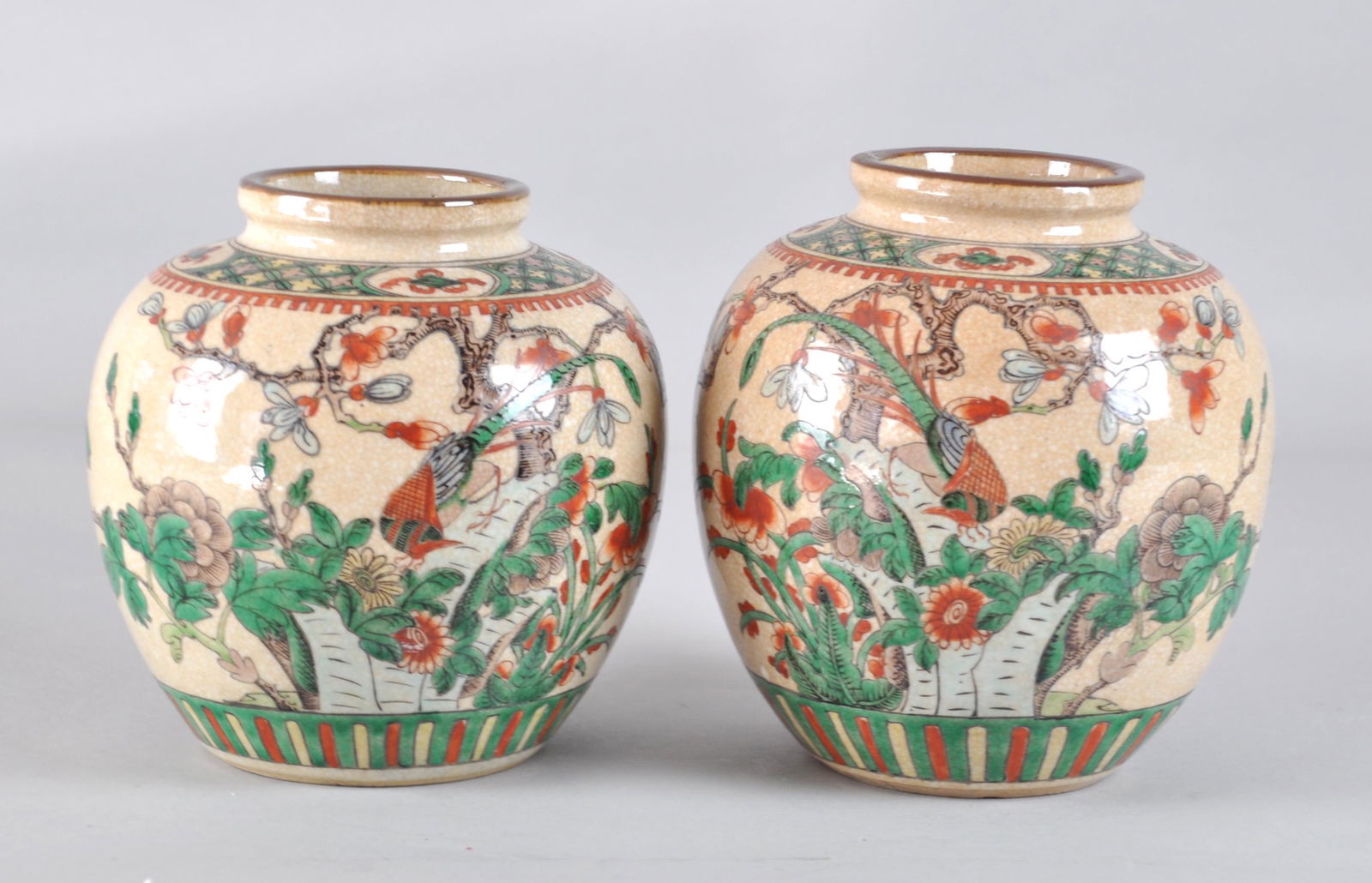 Chinese Pair Famille Verte Jars: Painted in flowers, birds in cracked style. Marked Kang Xi and China on the bottom. They measure 7.5" tall. 18-19th. C.. Good condition with age wears.