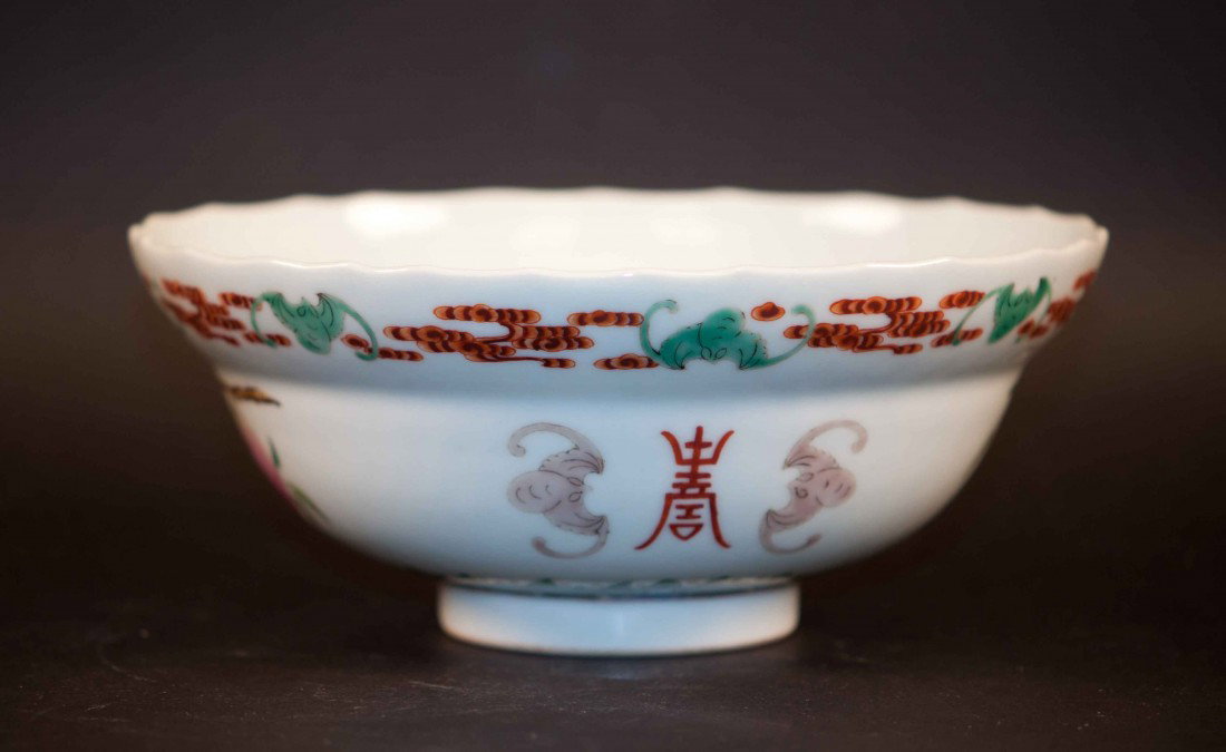 A Chinese Famille Rose Bowl: Decorated with bats, peaches, bearing a mark on the bottom, 7.25" wide and 3" deep. The shipping cost is $30 plus insurance in the US (excluding Hawaii and Alaska).