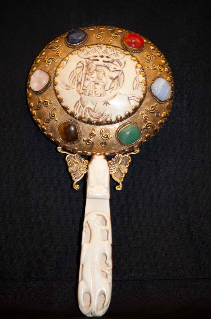 A Chinese Ivory Hand-Mirror: The handle is carved in dragon-head shape. 9.2" long and 4.5" wide for the mirror. The shipping cost is $28 plus insurance in the US( excluding Hawaii and Alaska)