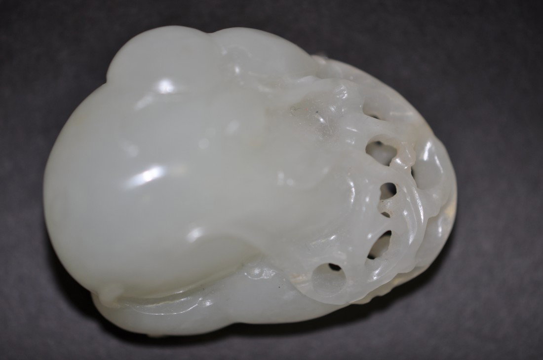 A Chinese White Jade Gourd: Carved in three gourds, 19th. C., 1.8" long. The shipping cost of this is $20 plus insurance in the US (excluding Hawaii and Alaska).