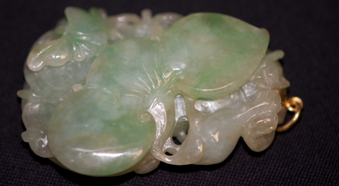 Chinese Jadeite Pendant in Ling-chi Plant: The jadeite pendant is carved in Ling-chi plant. 1.75" long and 1.25" wide. 19th. C. Very good condition