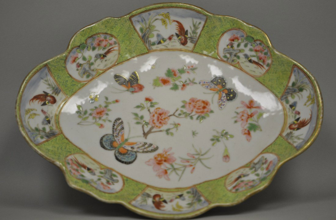 Chinese Famille Rose High-foot Platter: The platter is painted in beautiful butterfliers and flowers in the middle and with windows in different scenes. The outside of the platter is also painted in a romantic scene of a man and a woman wit
