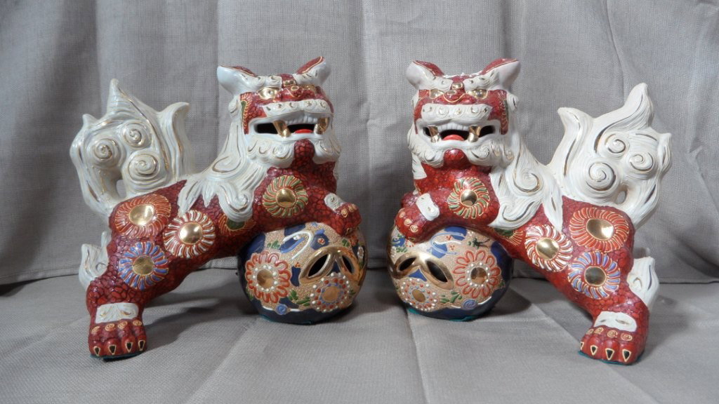 CHINESE MAY BE PORCELAIN LIONS: CHINESE,MAY BE PORCELAIN ,PAIR OF LIONS CLIMBING ON THE BALLS WITH THEIR FORE LEGS TURNING HEADS TO SIDE WITH THEIR MOUTHS OPEN NICELY PAINTED ALL OVER.HT.11 IN.W.12.5 IN.