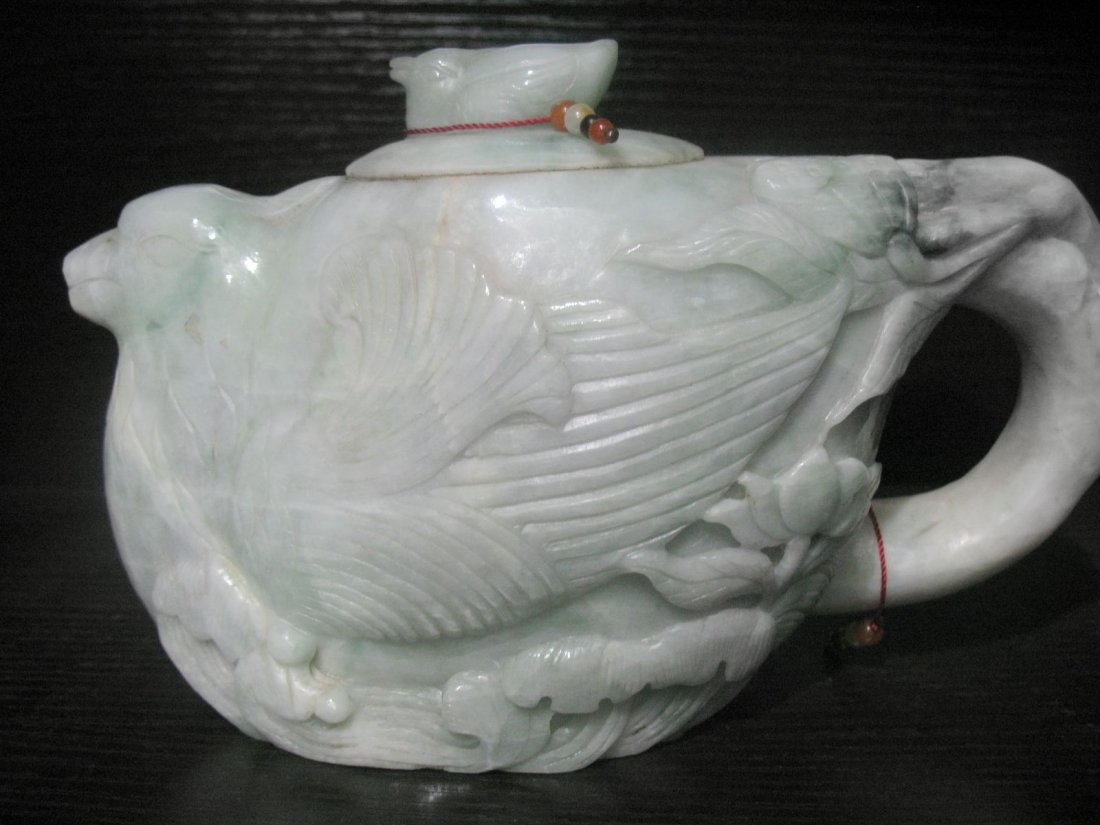 Very fine Chinese jade pot: Finely carved jade pot with a handle depicting beautiful raised carving of water lillies , bird and a bird mottif on the lid,long:4.3".