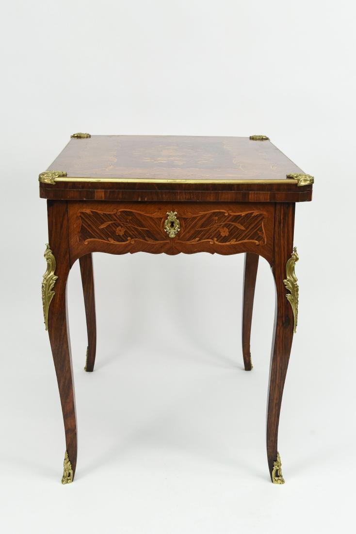 FRENCH ORMOLU FLIP TOP GAME TABLE: Dimensions: H 29.5" x W 31.5" x D 23.5" Condition: Nicks and scratches.