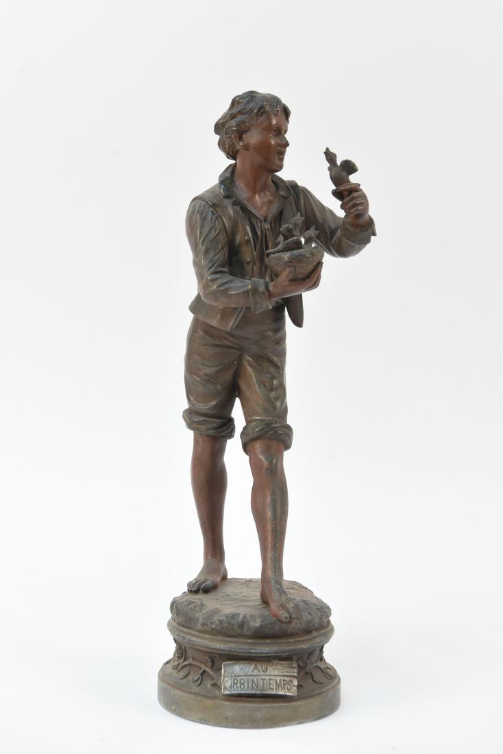L. RAPHAEL "AU PRINTEMPS" METAL SCULPTURE: Smelter metal, signed L. Raphael to back. Titled "Au Printemps" ("In Spring") to front. Depicts man holding bird's nest and birds. Dimensions: H 15.5" x Dia. 5" Condition: Some finish wear.