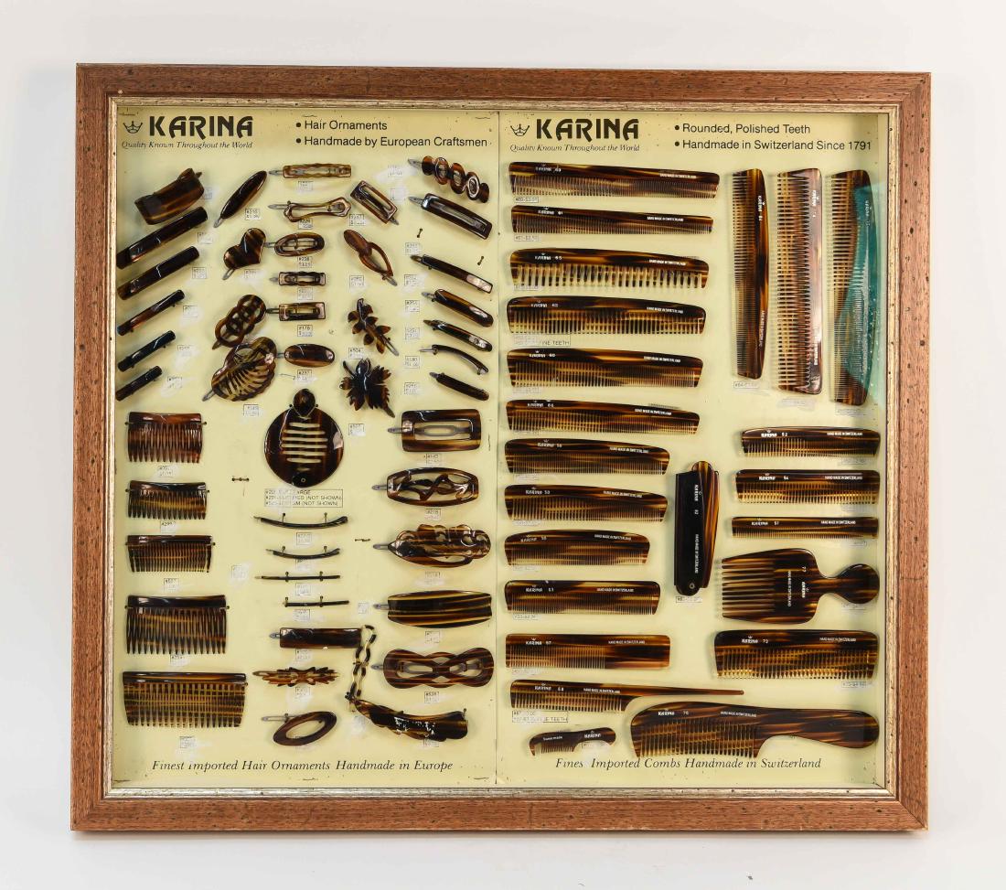 KARINA HAIR ORNAMENTS/COMBS SALESMAN SAMPLE: Dimensions: (Frame) H 24" x W 27" (Sight) H 21.5" x W 22.5" Condition: White paint marks covering original prices on board. Small comb missing few teeth. Few pin holes to board.