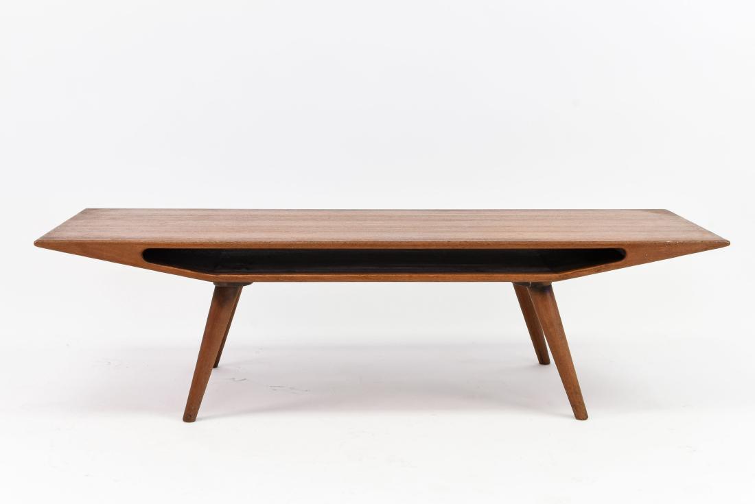 OMAN JUNN TEAK COFFEE TABLE: Dimensions: H 16" x W 59" x D 20.75" Condition: Repair to one leg. Some surface scratches to top have been repaired with wood stain.