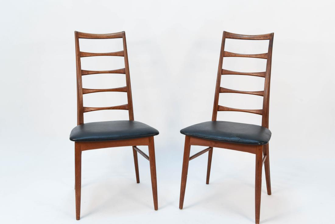 PAIR OF EVA CHAIRS BY NILS KOEFOED: Dimensions: H 37.5" x W 18.5" x D 20" Condition: Few scratches and scrapes to wood frame. Rip to one seat cushion. Some wear to both cushions.