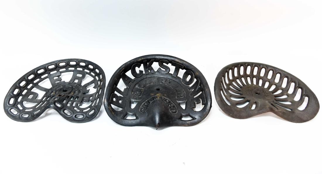(3) IRON TRACTOR SEATS: Includes Malta. Dimensions: H 12.5" x W 17.75" Condition: Consistent with age and use.