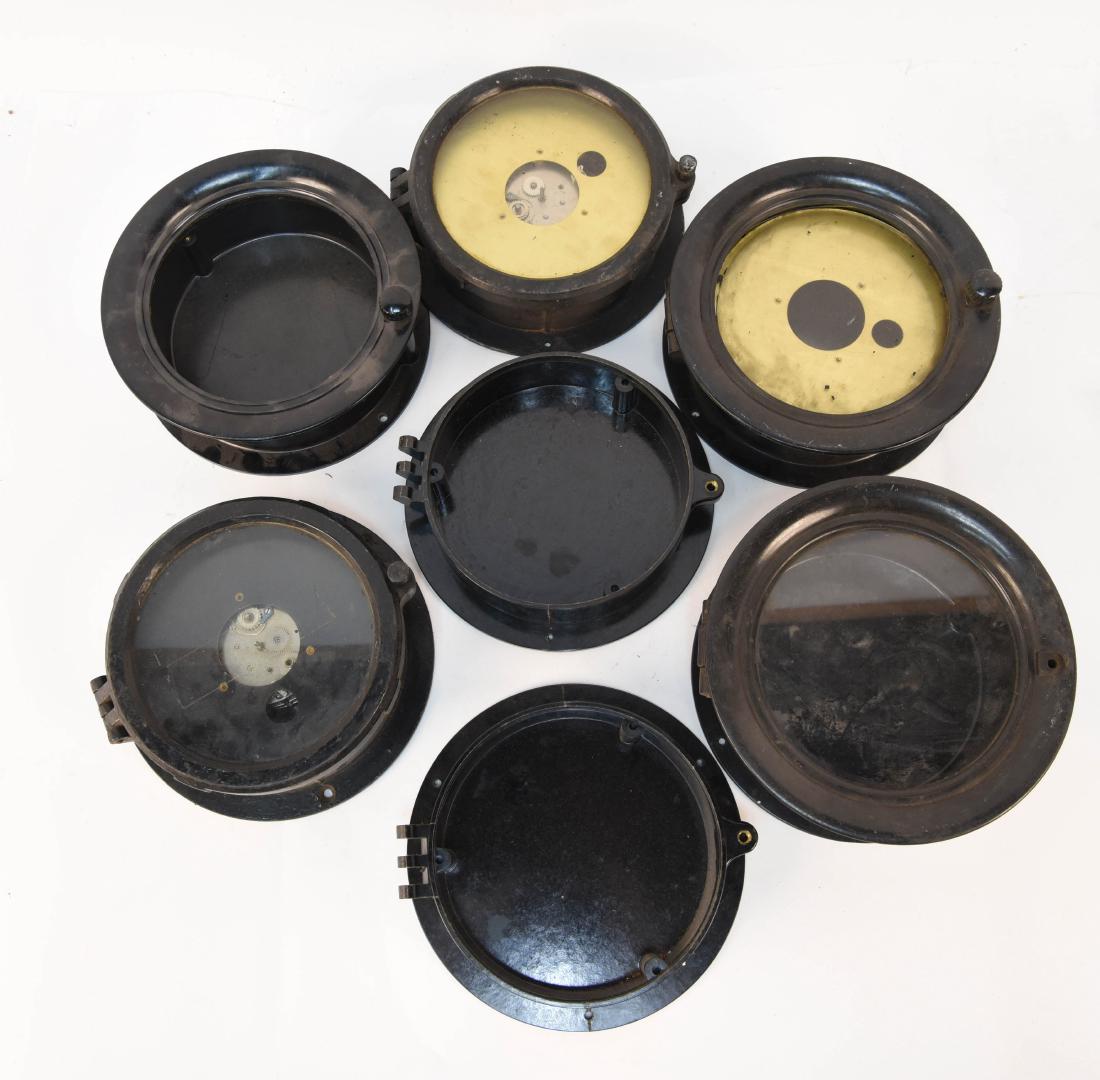 GROUPING OF SHIPS DECK CLOCK CASES: (7) pieces. Dimensions: (Largest) H 3.25" x Dia. 7.5" Condition: Some missing front. Light wear.