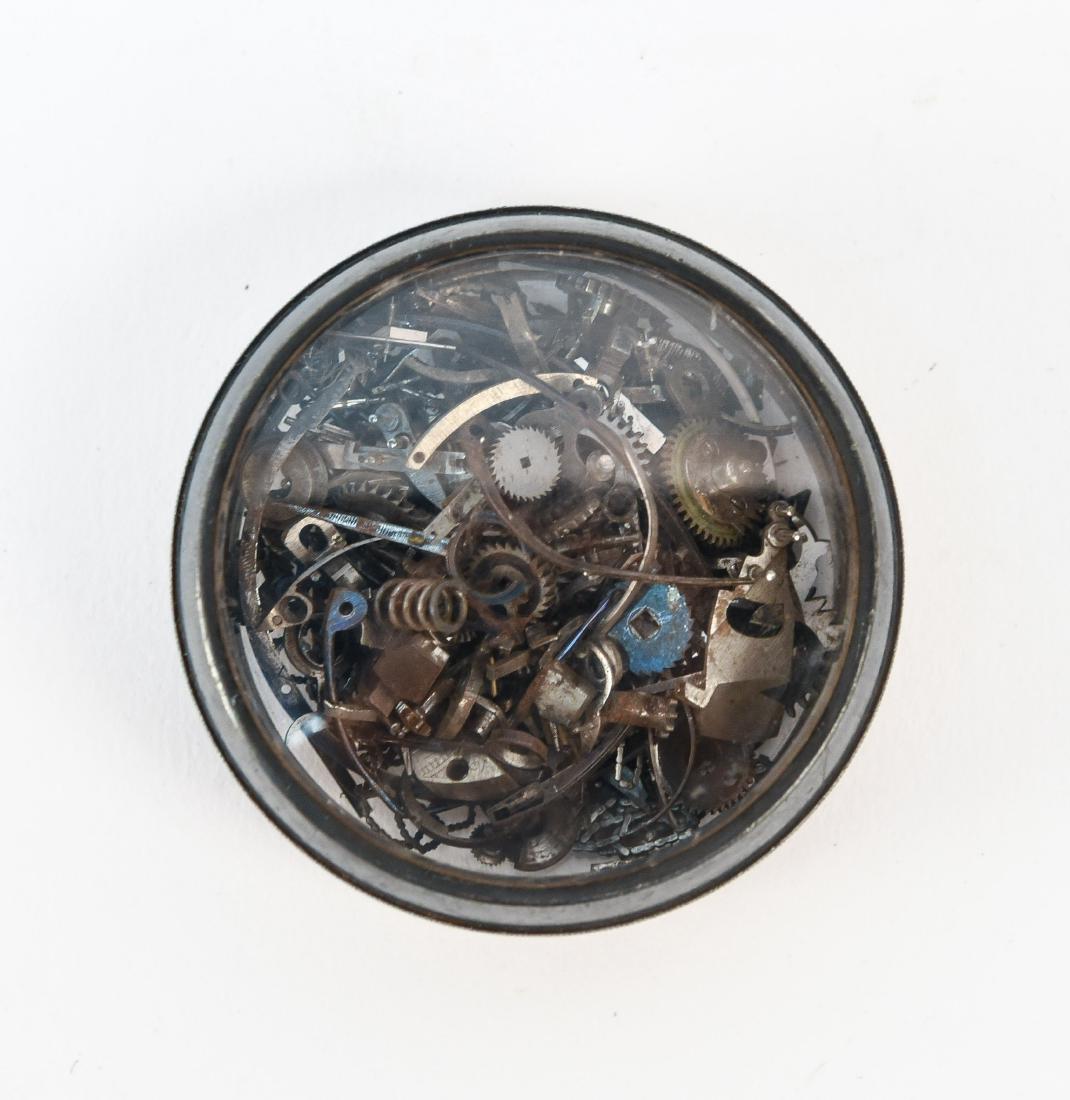 WATCH PARTS IN SILVER AND GLASS CASE: Dimensions: Dia. 2" x D .75" Condition: Normal wear.