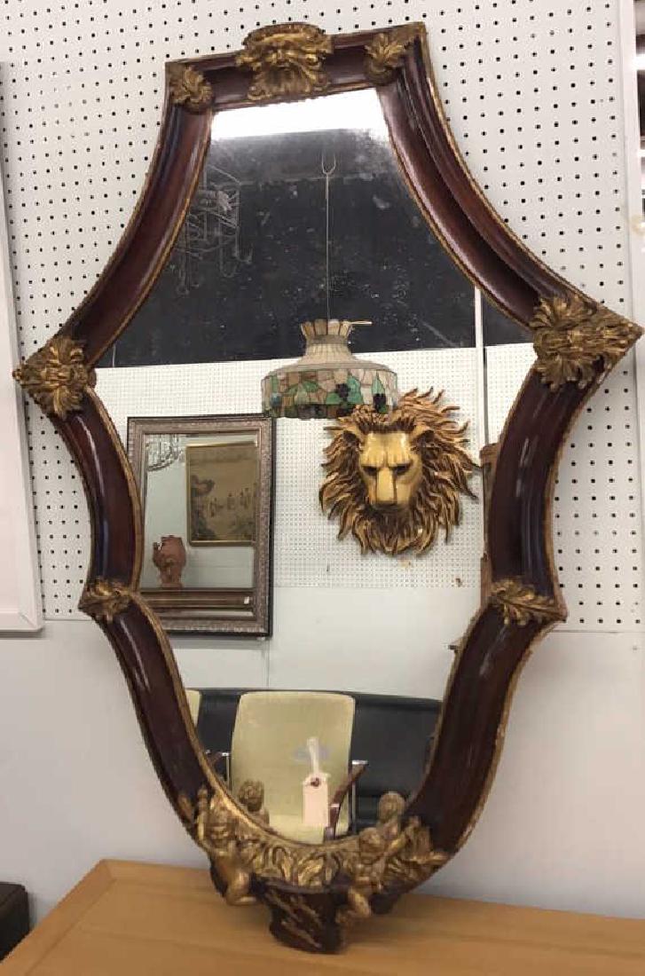 DECORATIVE PUTTI MIRROR: Dimensions: H 51.5" x W 38" Condition: Few small losses. Some chipping to gilding.