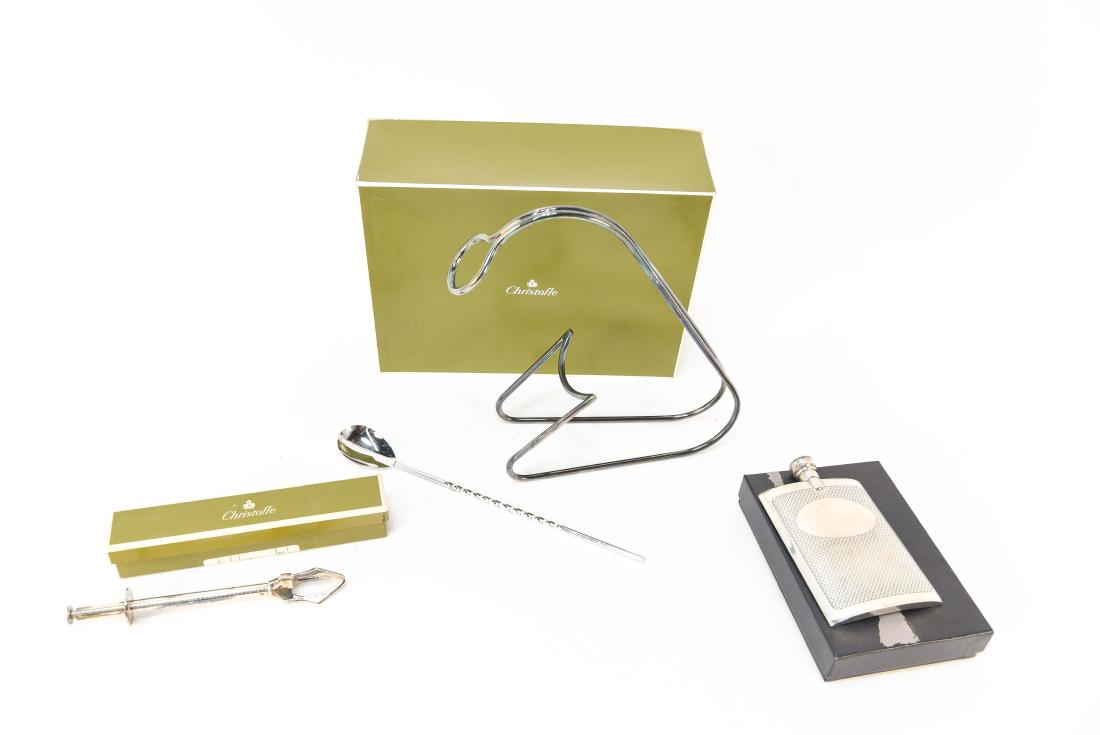 SILVERPLATE INCLUDING CHRISTOFLE: Olive tongs, Bottle holder, English pewter flask. All Christofle with hallmarks and original boxes. Dimensions: (Wine holder) H 10" x W 7" Condition: Used, usable, some tears to the boxes.