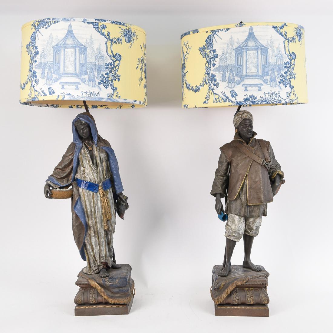 PAIR OF VIENNESE STYLE WHITE METAL ORIENTALIST LAMPS: In the manner of Louis Hottot. White metal/smelter. 1910 - 1920's. Dimensions: H 39.75" x W 17" x D 17"Condition: Some minor chipping of paint, areas may have been repainted.