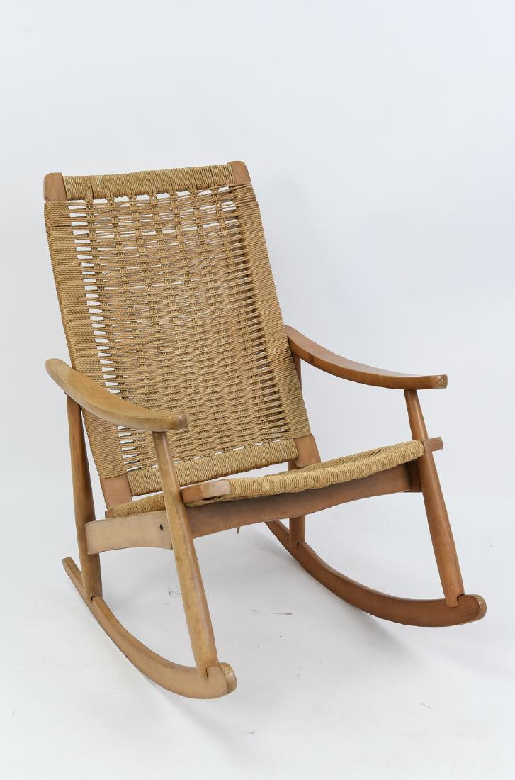 HANS WEGNER STYLE WOVEN ROCKING CHAIR: Dimensions: H 38" x W 25" x D 32" Condition: Some scratches, scuffs, and dings. Some of the seat cushion weave has come undone.