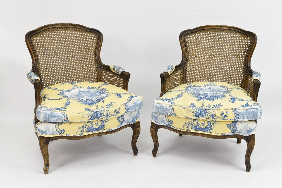 PAIR OF FRENCH COUNTRY BERGERE CHAIRS: Dimensions: H 35" x W 27.5" x D 21" Condition: Some minor dings and scratches to wood consitent with age and use.